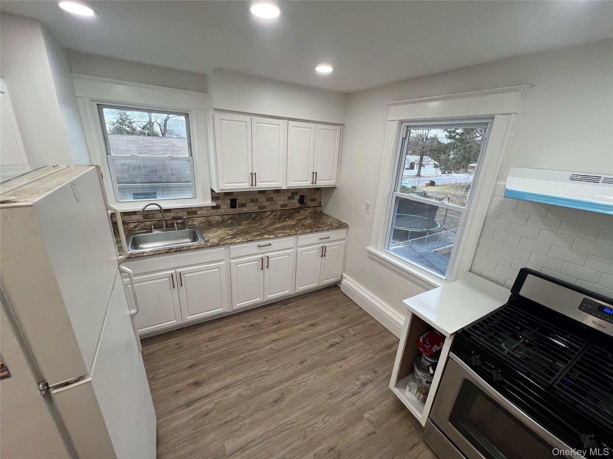 175 Washington Street, Unit 2 Poughkeepsie, NY 12601 - Photo 1 of 1 a kitchen with granite countertop a stove and cabinets
