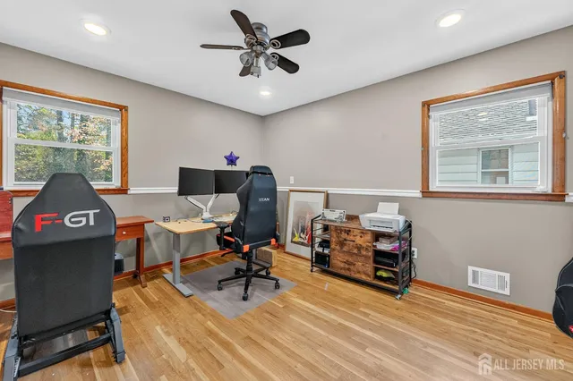 a living room with furniture a flat screen tv and a window