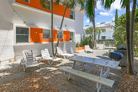 a view of a patio with table and chairs and potted plants