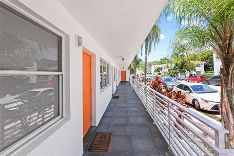 a view of a kitchen with a sink dishwasher and wooden floor