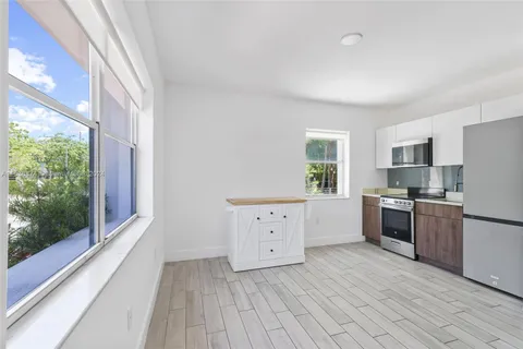 a kitchen with stainless steel appliances a refrigerator sink and stove