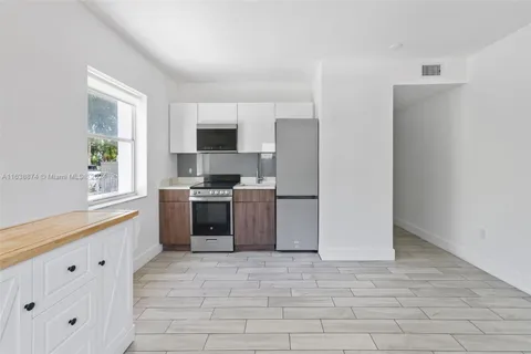 a kitchen with a refrigerator stove and microwave