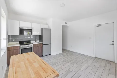 a kitchen with stainless steel appliances granite countertop a refrigerator sink and stove