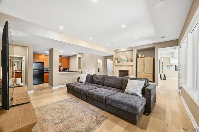 a kitchen with stainless steel appliances granite countertop a sink a stove and a refrigerator