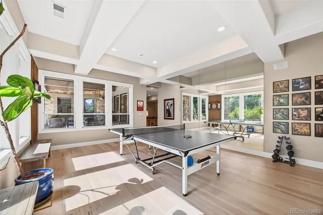 a living room with furniture a flat screen tv and a table