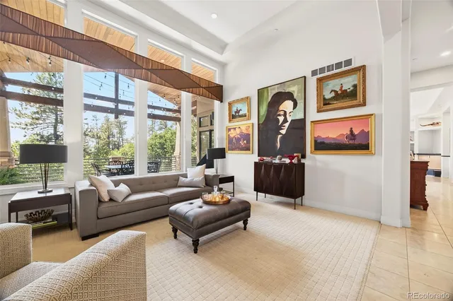 a living room with furniture a window and a flat screen tv