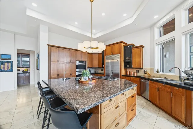 a kitchen with center island table and chairs in it
