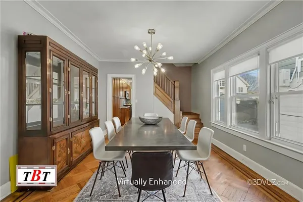 a view of a dining room with furniture a chandelier and wooden floor