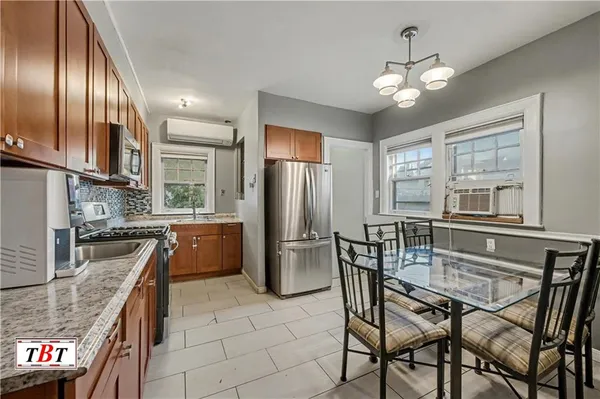 a kitchen with stainless steel appliances granite countertop a stove top oven a refrigerator a sink and dishwasher