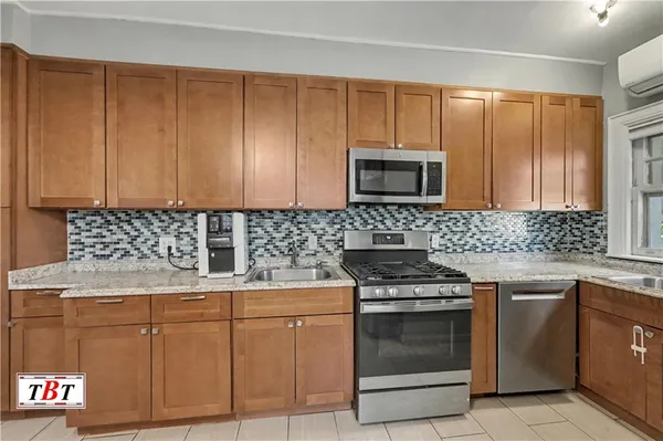a kitchen with granite countertop cabinets stainless steel appliances and a sink