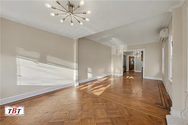 a view of an empty room with window and stairs