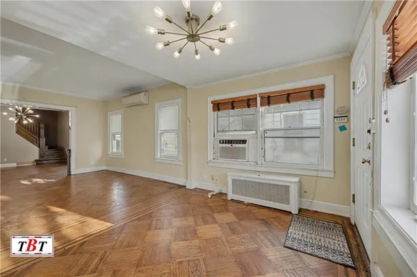 an empty room with windows and ceiling fan