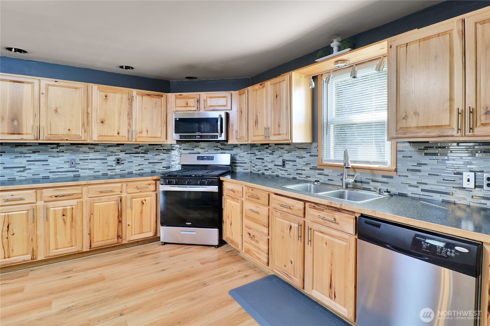 108 2nd Street Southeast Rainier, WA 98576 - Photo 11 of 40 a kitchen with stainless steel appliances granite countertop a stove a sink and white cabinets