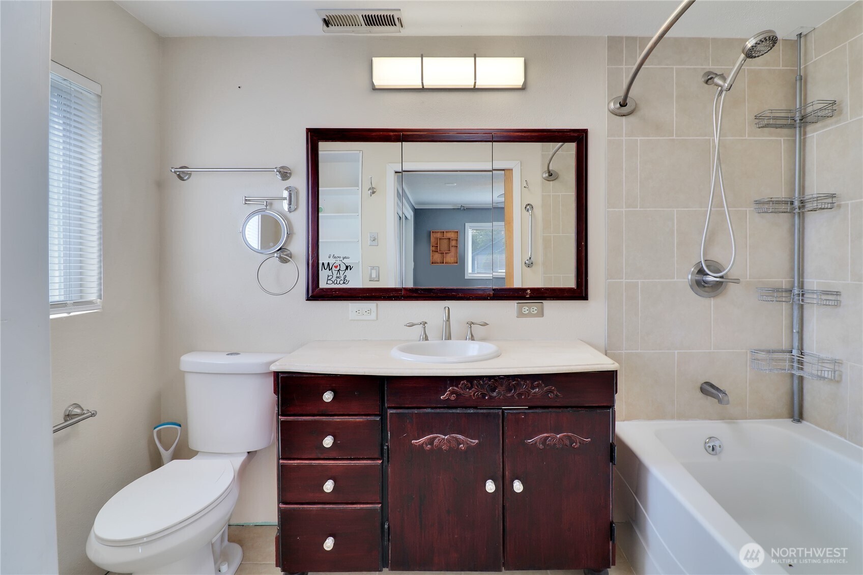 108 2nd Street Southeast Rainier, WA 98576 - Photo 17 of 40 a bathroom with a toilet a sink a bathtub and a mirror