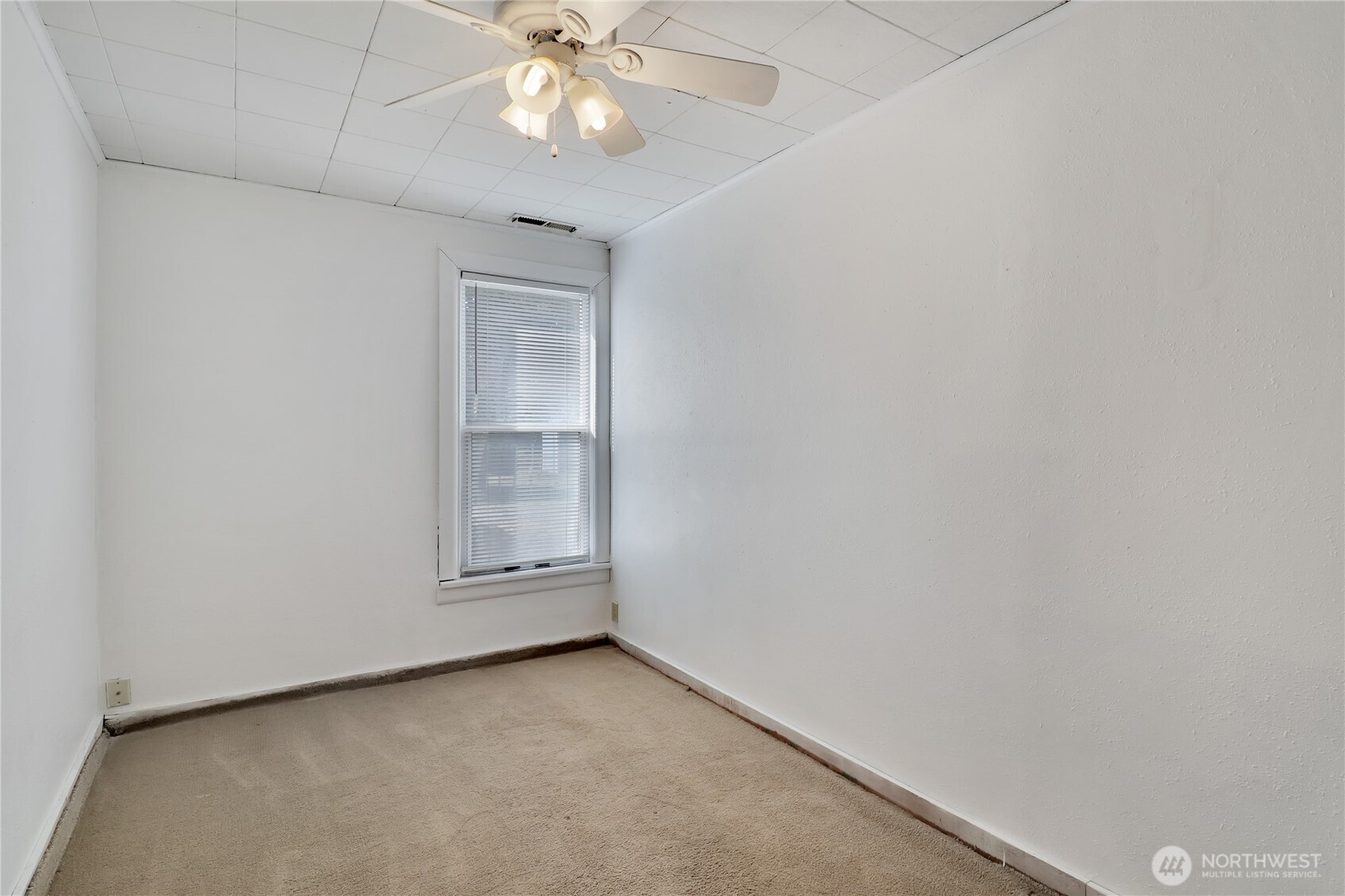 108 2nd Street Southeast Rainier, WA 98576 - Photo 21 of 40 an empty room with a chandelier fan and a window
