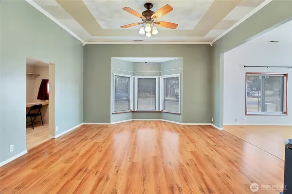 a bedroom with a large bed and a chandelier fan