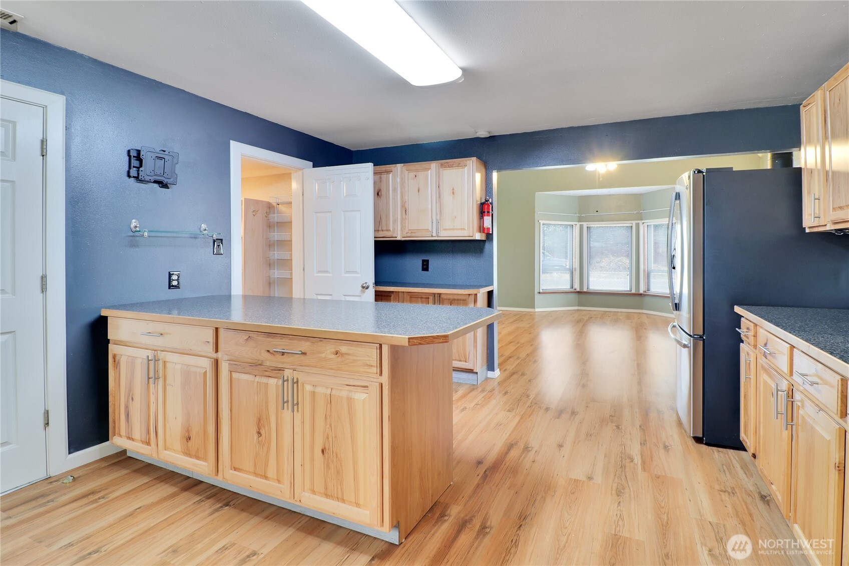 108 2nd Street Southeast Rainier, WA 98576 - Photo 9 of 40 a kitchen with stainless steel appliances granite countertop a stove a sink and a refrigerator with wooden floor