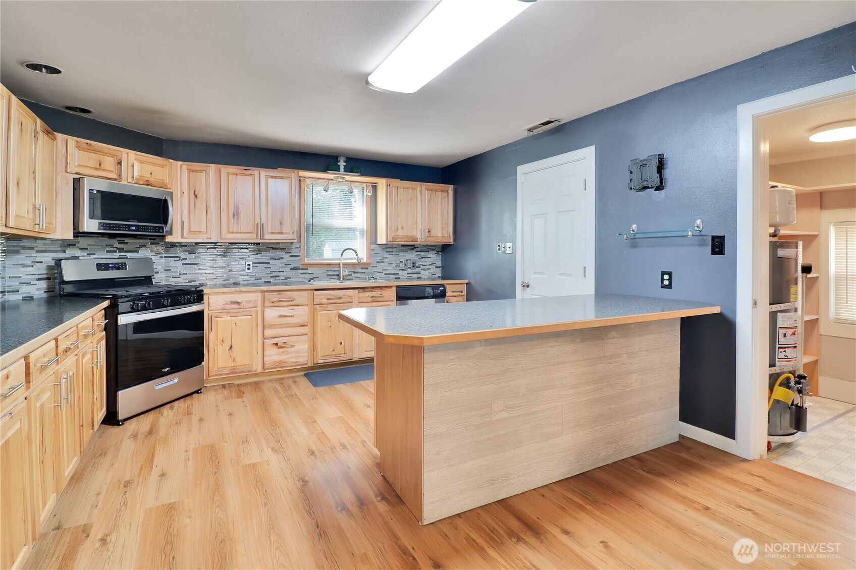 108 2nd Street Southeast Rainier, WA 98576 - Photo 10 of 40 a kitchen with stainless steel appliances granite countertop a stove top oven a sink dishwasher and a refrigerator