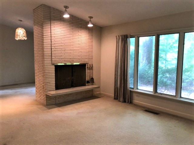 3307 Timberlake Road Raleigh, NC 27604 - Photo 8 of 21 a view of an empty room with a fireplace and a window
