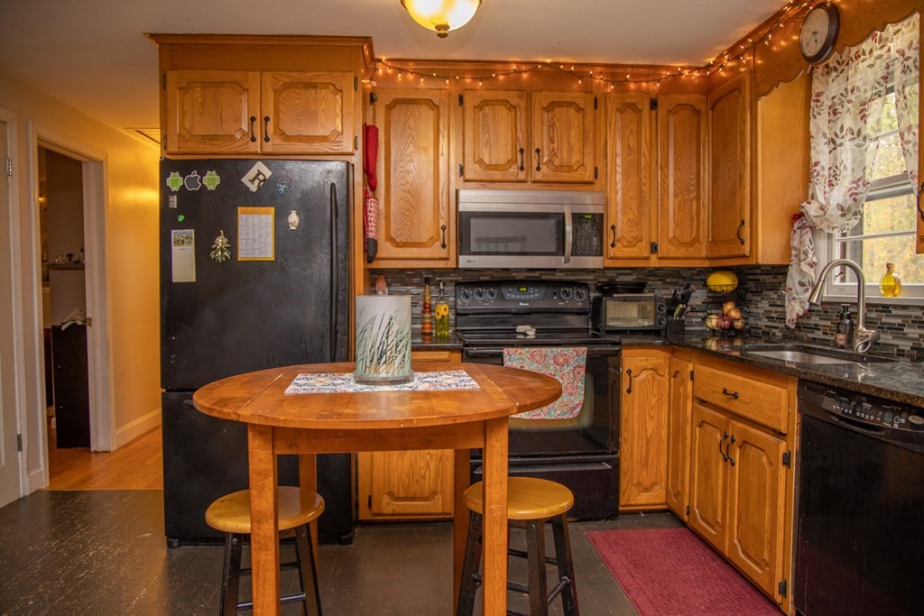 75 Sagamore Road West Springfield, MA 01089 - Photo 12 of 24 a kitchen with stainless steel appliances wooden floors and wooden cabinets