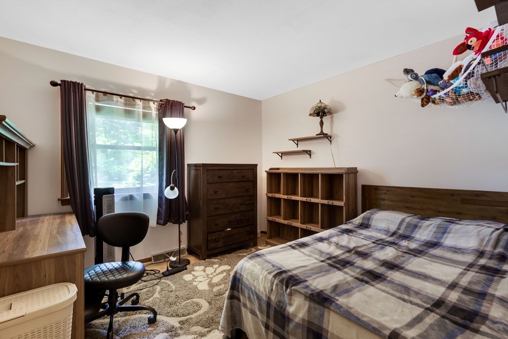 15 Conestoga Road Lexington, MA 02421 - Photo 17 of 31 a bedroom with a bed and a chandelier