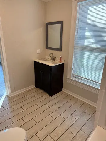 a bedroom with a bed and a potted plant