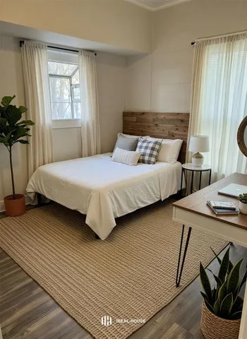 a bedroom with double bed and a window