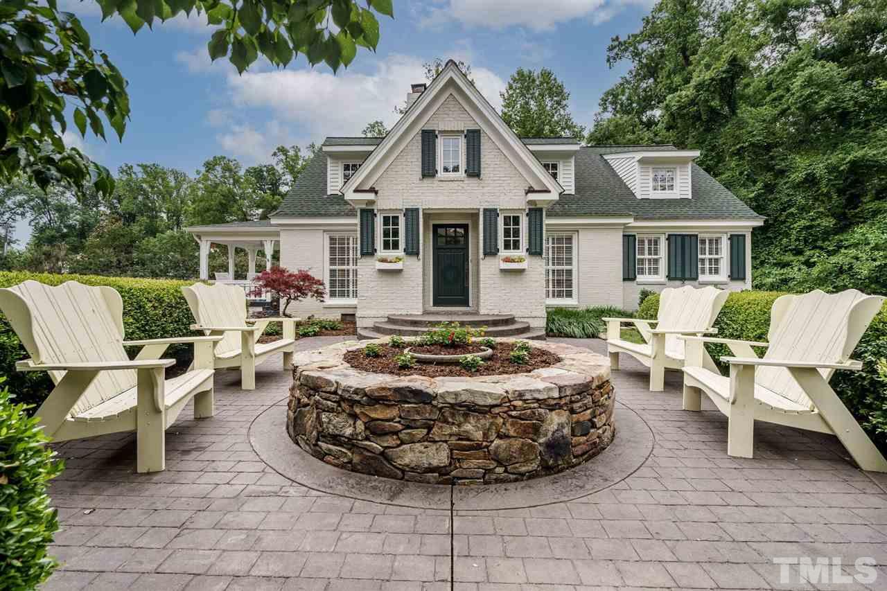 a front view of a house with outdoor seating