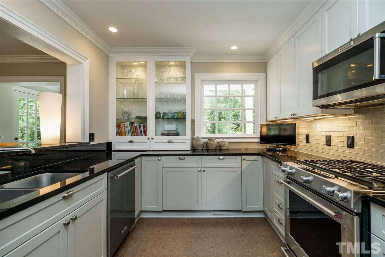 503 Yarmouth Road Raleigh, NC 27608 - Photo 16 of 30 a kitchen with a sink stove top oven and refrigerator
