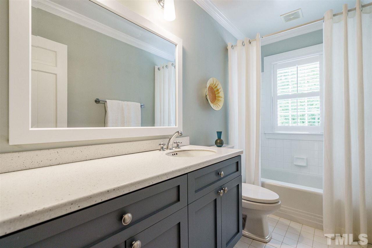 503 Yarmouth Road Raleigh, NC 27608 - Photo 20 of 30 a bathroom with a granite countertop sink a toilet and a shower