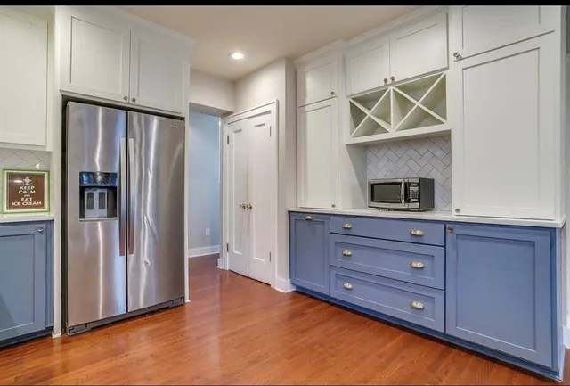 a room with wooden floor and cabinets