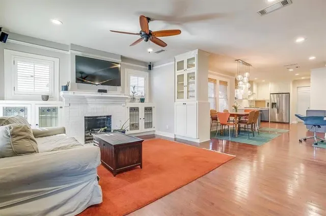a living room with furniture fireplace and flat screen tv