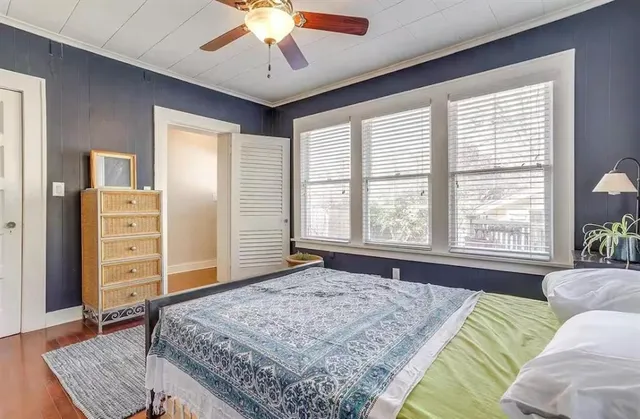 a spacious bedroom with a bed and a dresser