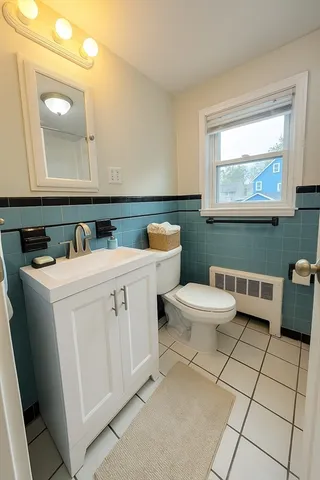 a bathroom with a toilet a sink and mirror