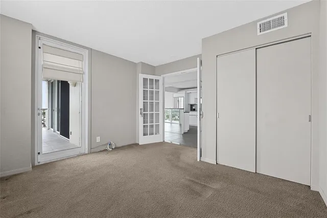 a view of empty room with cabinet and refrigerator