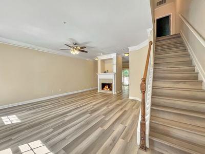 1232 Harris Commons Place, Unit 15 Roswell, GA 30076 - Photo 2 of 36 a view of a livingroom with wooden floor and staircase