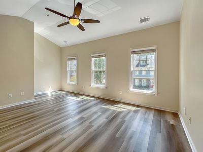 1232 Harris Commons Place, Unit 15 Roswell, GA 30076 - Photo 21 of 36 a view of empty room with wooden floor and fan