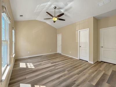 1232 Harris Commons Place, Unit 15 Roswell, GA 30076 - Photo 22 of 36 a view of empty room with wooden floor and fan