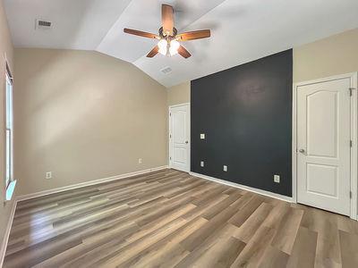 1232 Harris Commons Place, Unit 15 Roswell, GA 30076 - Photo 28 of 36 wooden floor in an empty room with a chandelier fan