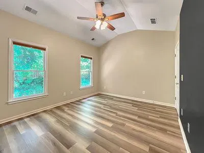 wooden floor in an empty room with a window