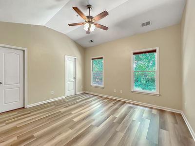 1232 Harris Commons Place, Unit 15 Roswell, GA 30076 - Photo 30 of 36 a view of an empty room with a window and a chandelier fan