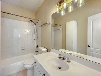 1232 Harris Commons Place, Unit 15 Roswell, GA 30076 - Photo 32 of 36 a bathroom with a sink a toilet and shower