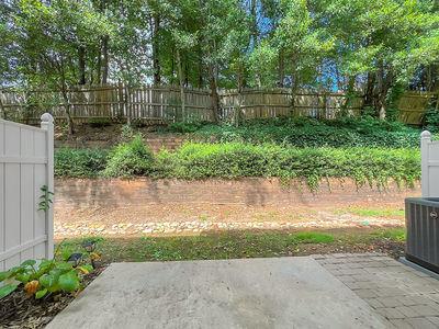 1232 Harris Commons Place, Unit 15 Roswell, GA 30076 - Photo 35 of 36 a backyard of a house with lots of green space and plants
