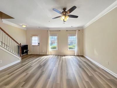 1232 Harris Commons Place, Unit 15 Roswell, GA 30076 - Photo 4 of 36 an empty room with wooden floor and windows