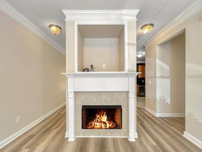 1232 Harris Commons Place, Unit 15 Roswell, GA 30076 - Photo 5 of 36 a living room with a fireplace and a rug