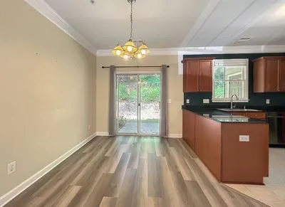 a open kitchen with granite countertop a sink window and refrigerator