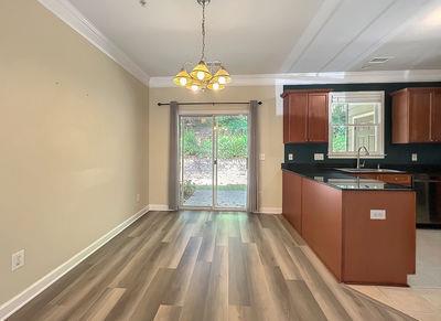1232 Harris Commons Place, Unit 15 Roswell, GA 30076 - Photo 7 of 36 a open kitchen with granite countertop a sink window and refrigerator