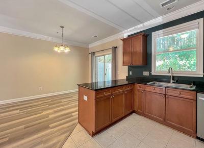 1232 Harris Commons Place, Unit 15 Roswell, GA 30076 - Photo 10 of 36 a kitchen with stainless steel appliances granite countertop a sink and cabinets