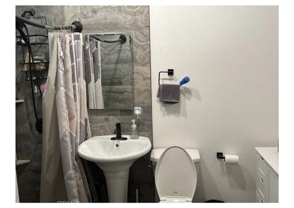 a bathroom with a sink mirror and vanity