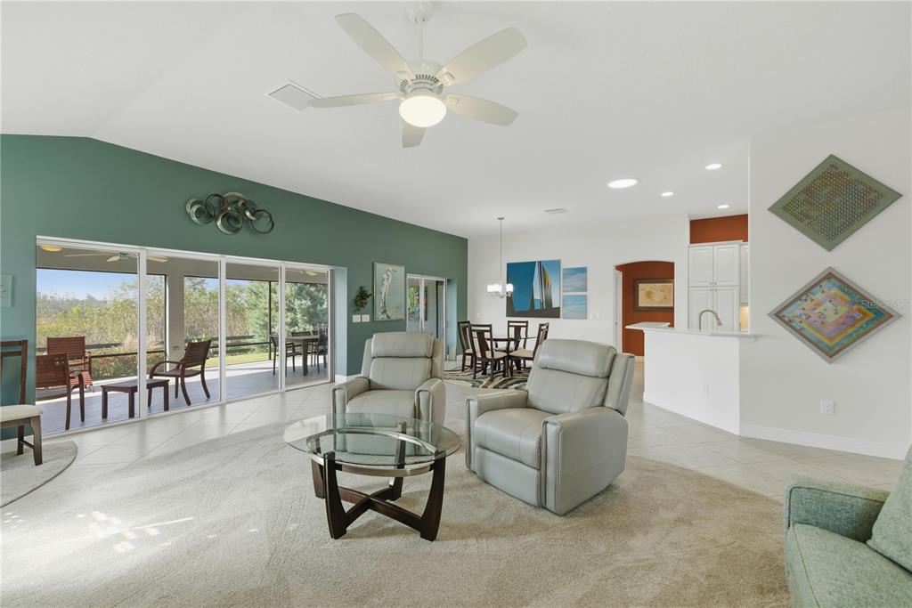 1016 Pickering Path The Villages, FL 32163 - Photo 12 of 38 a living room with furniture a flat screen tv and a large window